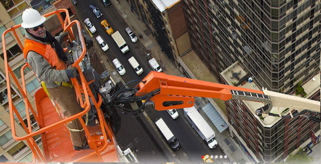 large crane by roof among high rise buildings